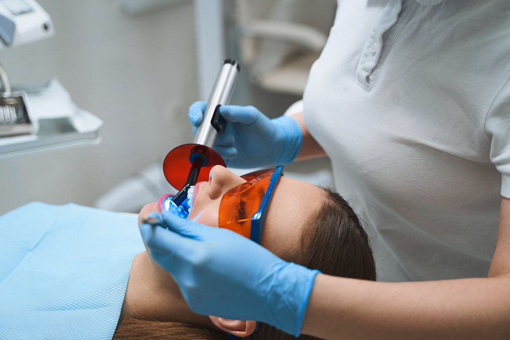 Dentist giving root canal to patient stock photo