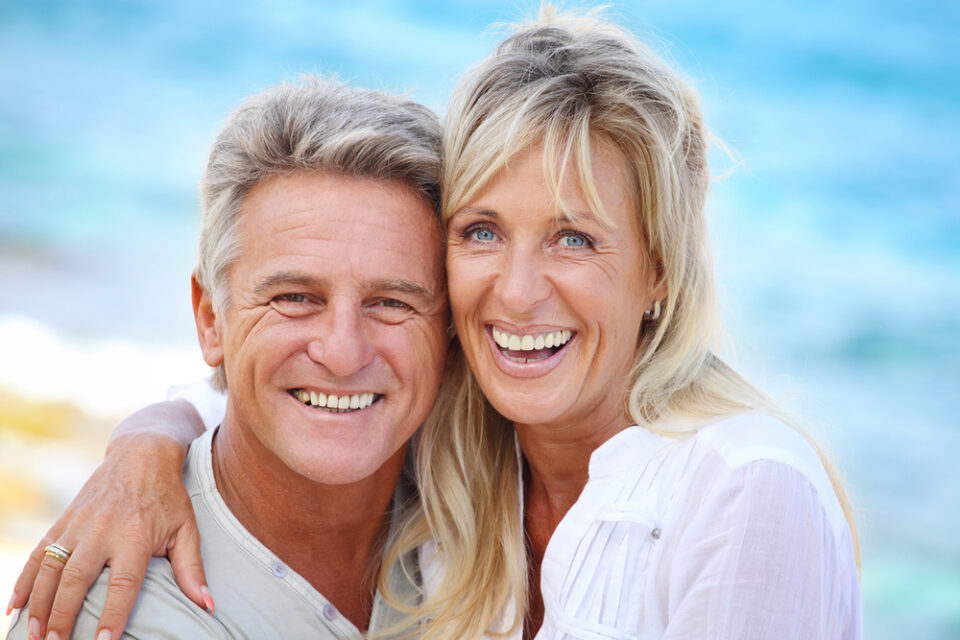 closeup of mature couple smiling tooth replacement McKinney TX